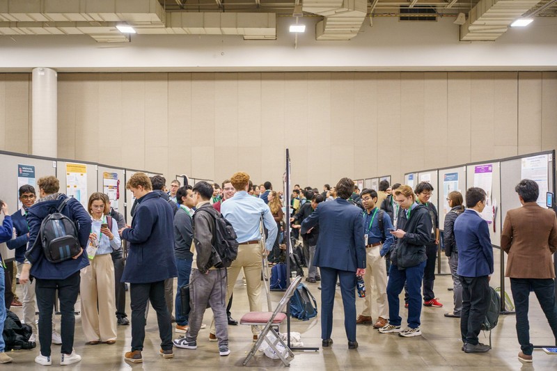 Attendees and presenters at a poster session 