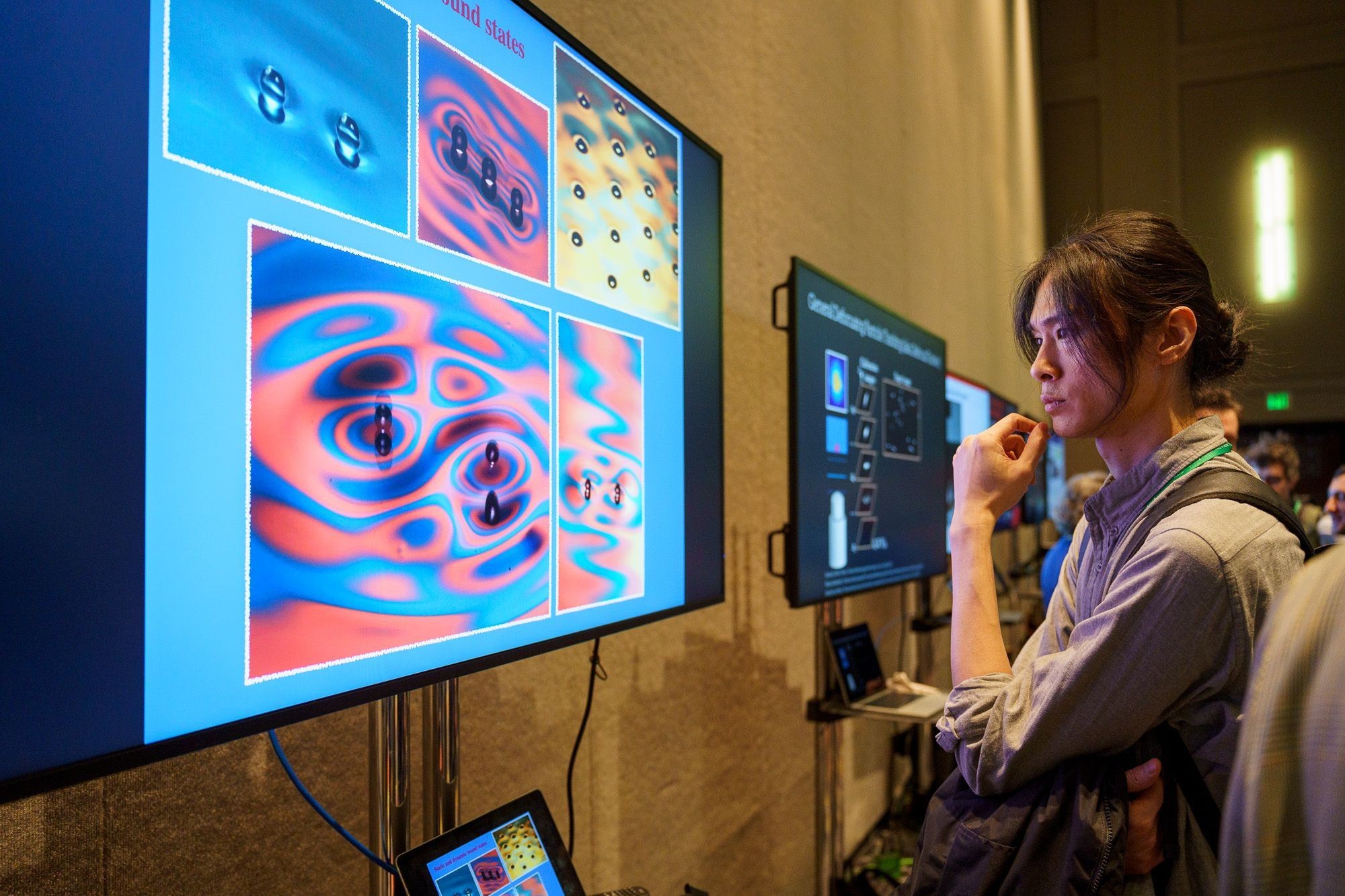 An attendee at the DFD meeting looks at a screen of fluid images